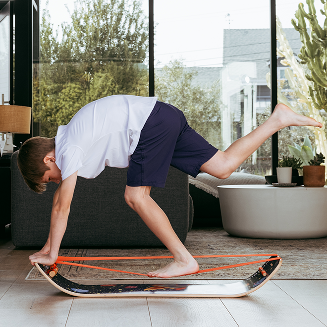 Child playing with an Astro slackboard plus in a living room