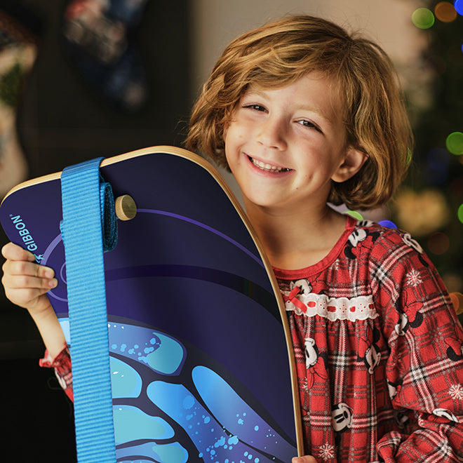 Child holding a butterfly SlackBoard with a blurred background