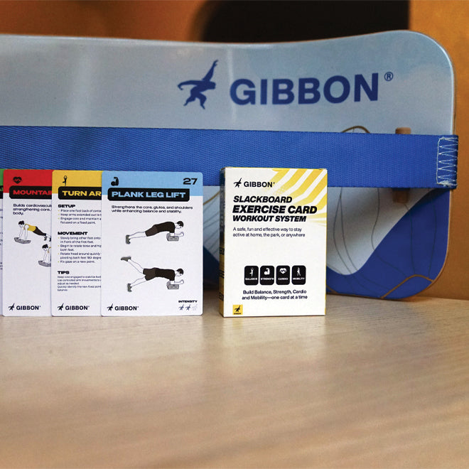 Gibbon Slackboard and workout cards on a wooden surface