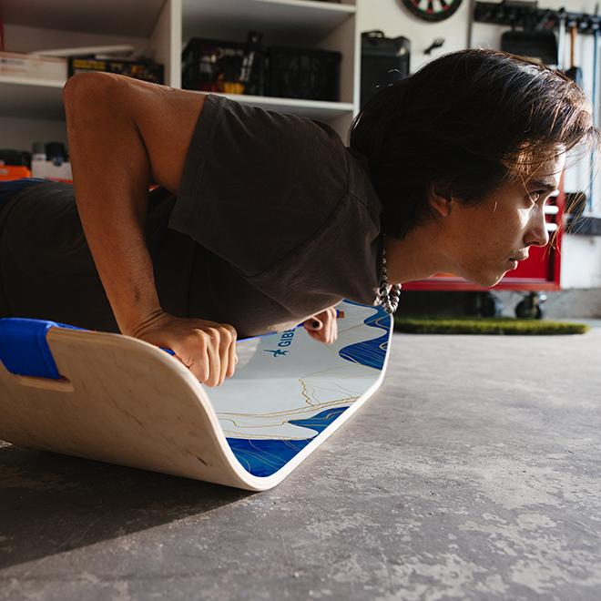 Person using a Mountain SlackBoard to do a push up in his garage
